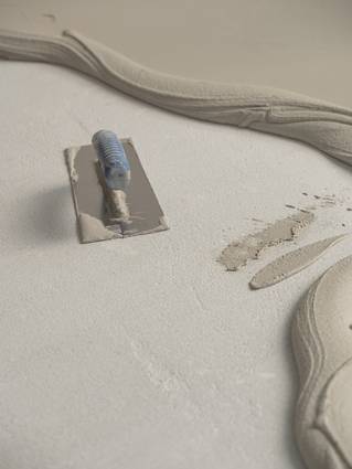 Socrete aanbrengen met spatel op chape