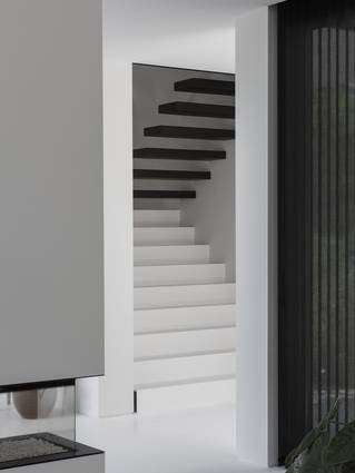 Escalier blanc avec sol coulé Mellow blanc et marches flottantes noires